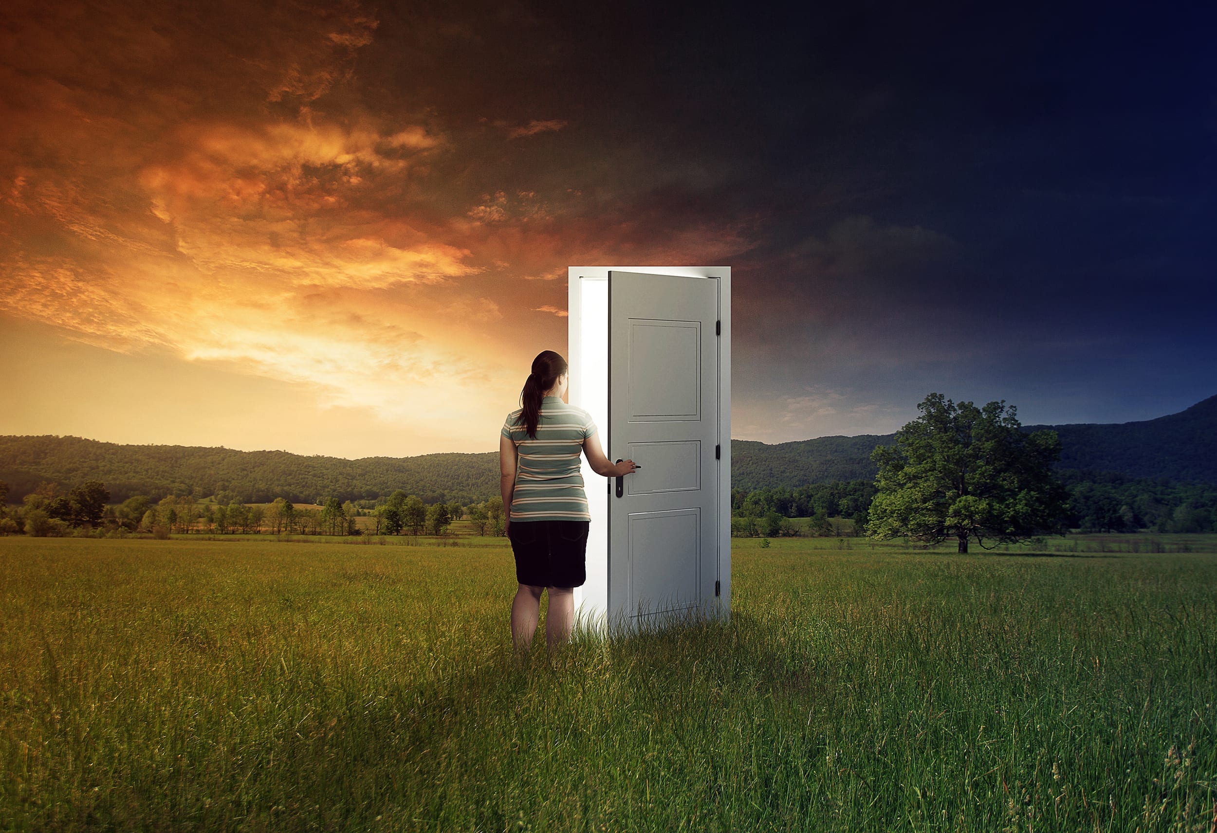 woman opens door in field