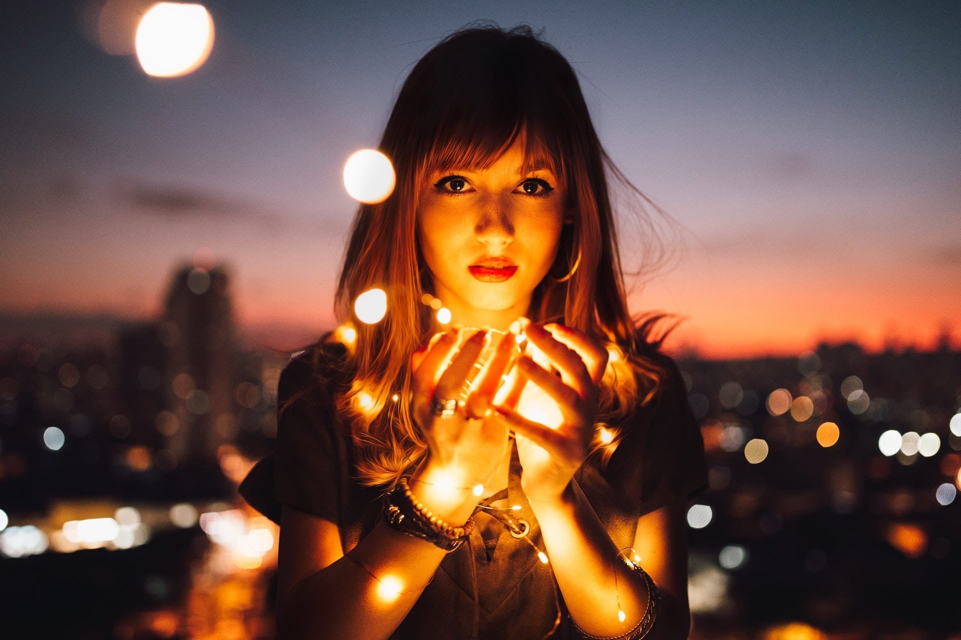 young girl holds light in her hands