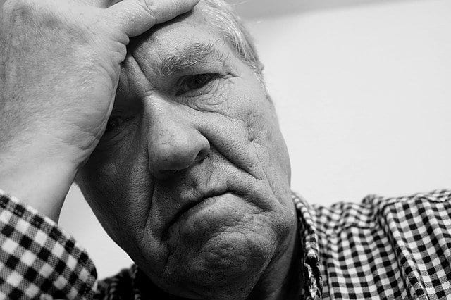 elderly man struggling with manifestation blocks