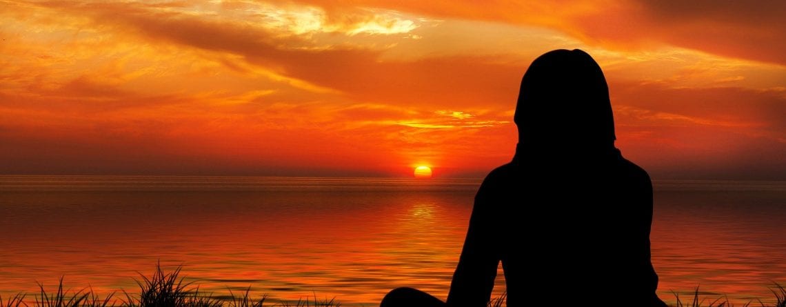 meditating at sunset